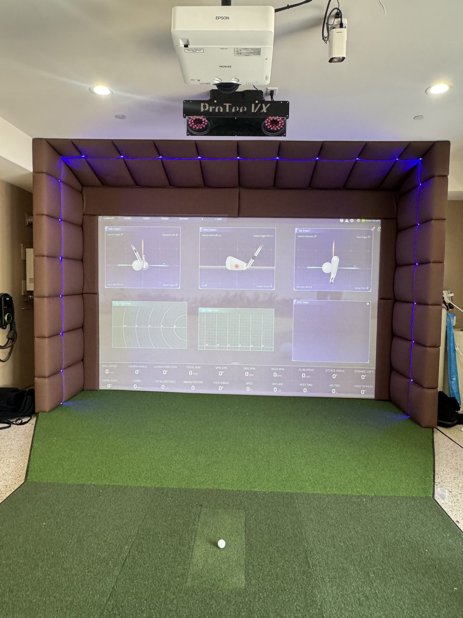 Custom upholstered padded panels around a home golf simulator